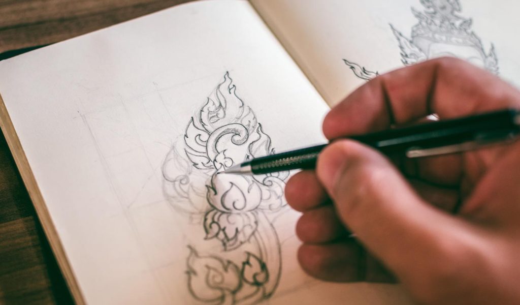 Person doodling in an artist's sketchbook